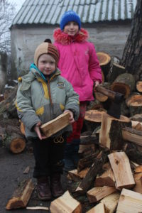 Ukrainian children with donated firewood