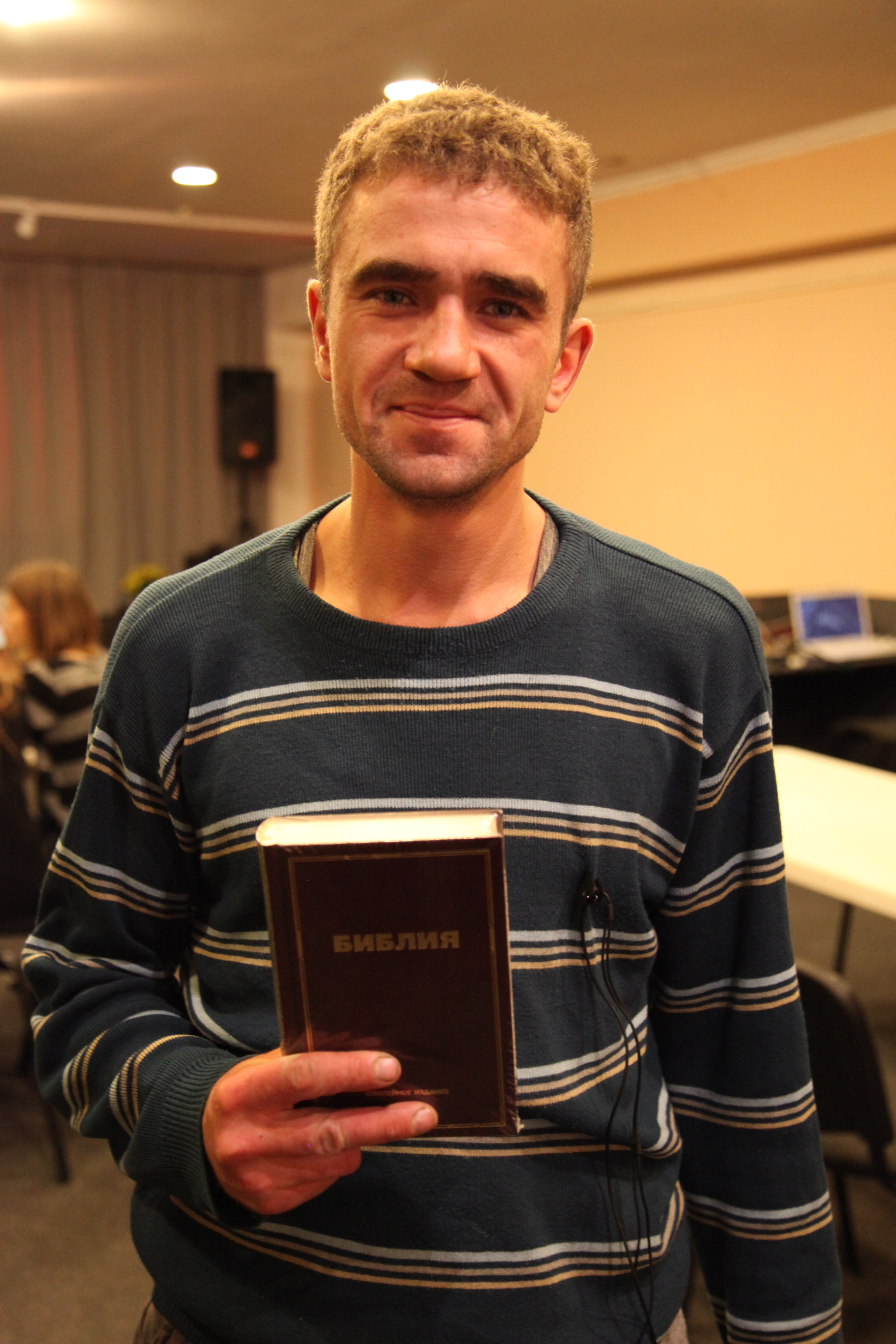 School Without Walls leader holding a Bible