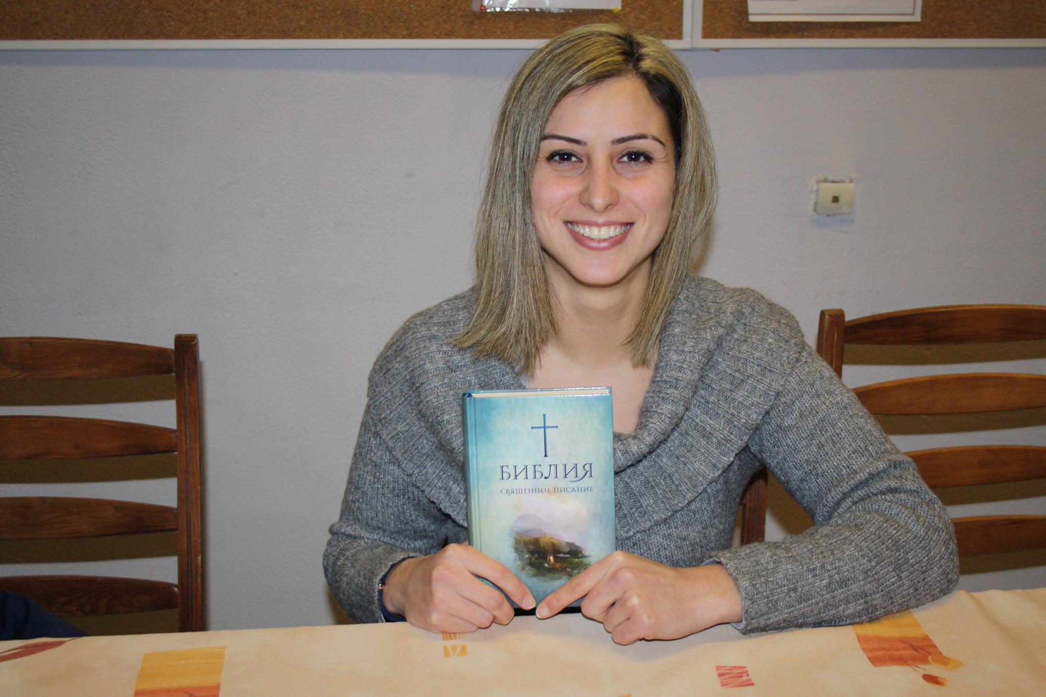 School Without Walls leader holding a Bible