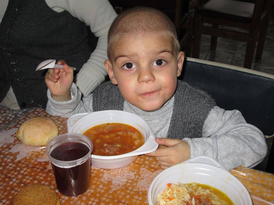 Young boy eating rice meals in Ukraine