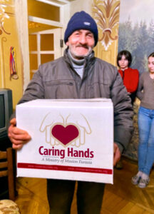 man with caring hands food box