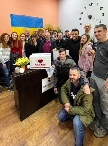 group inside with caring hands food boxes