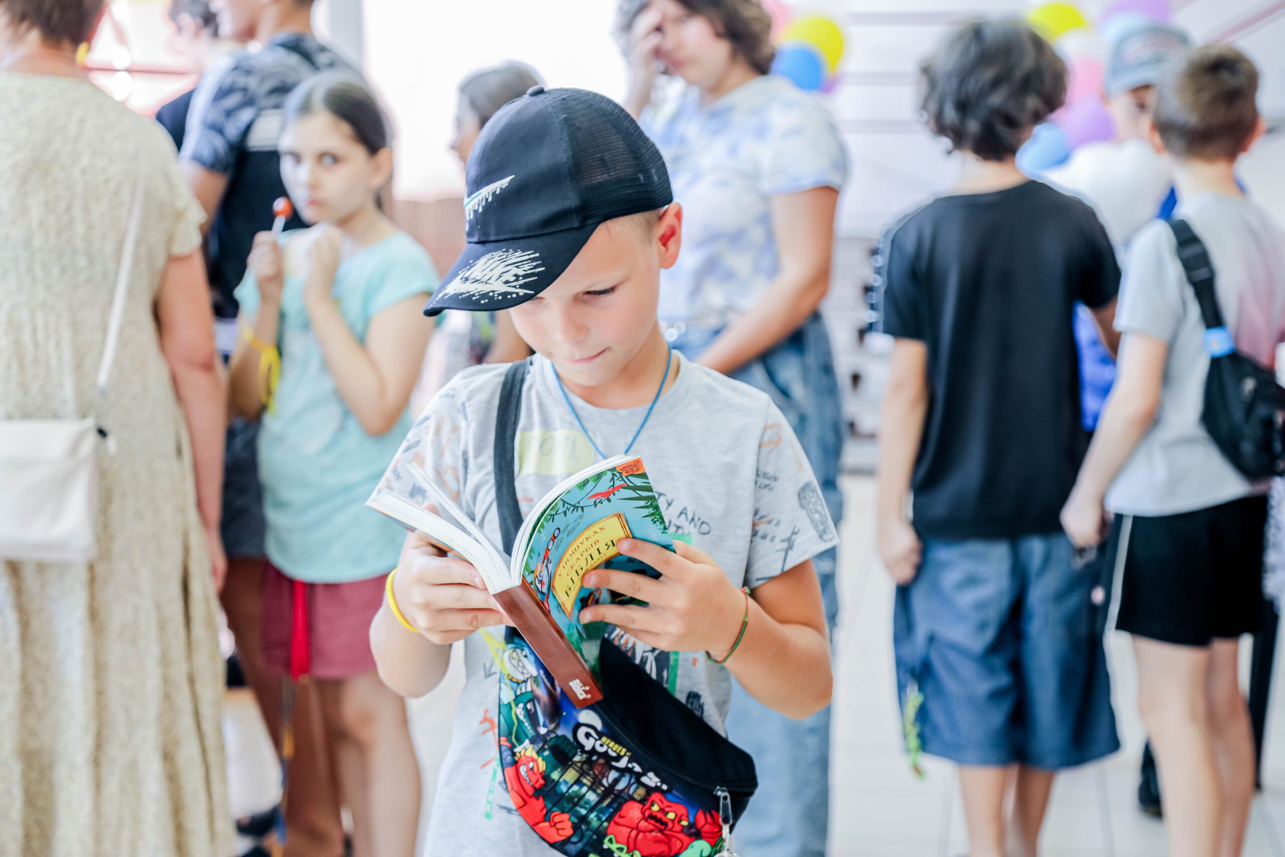 Boy with had reading bible at summer bible camp
