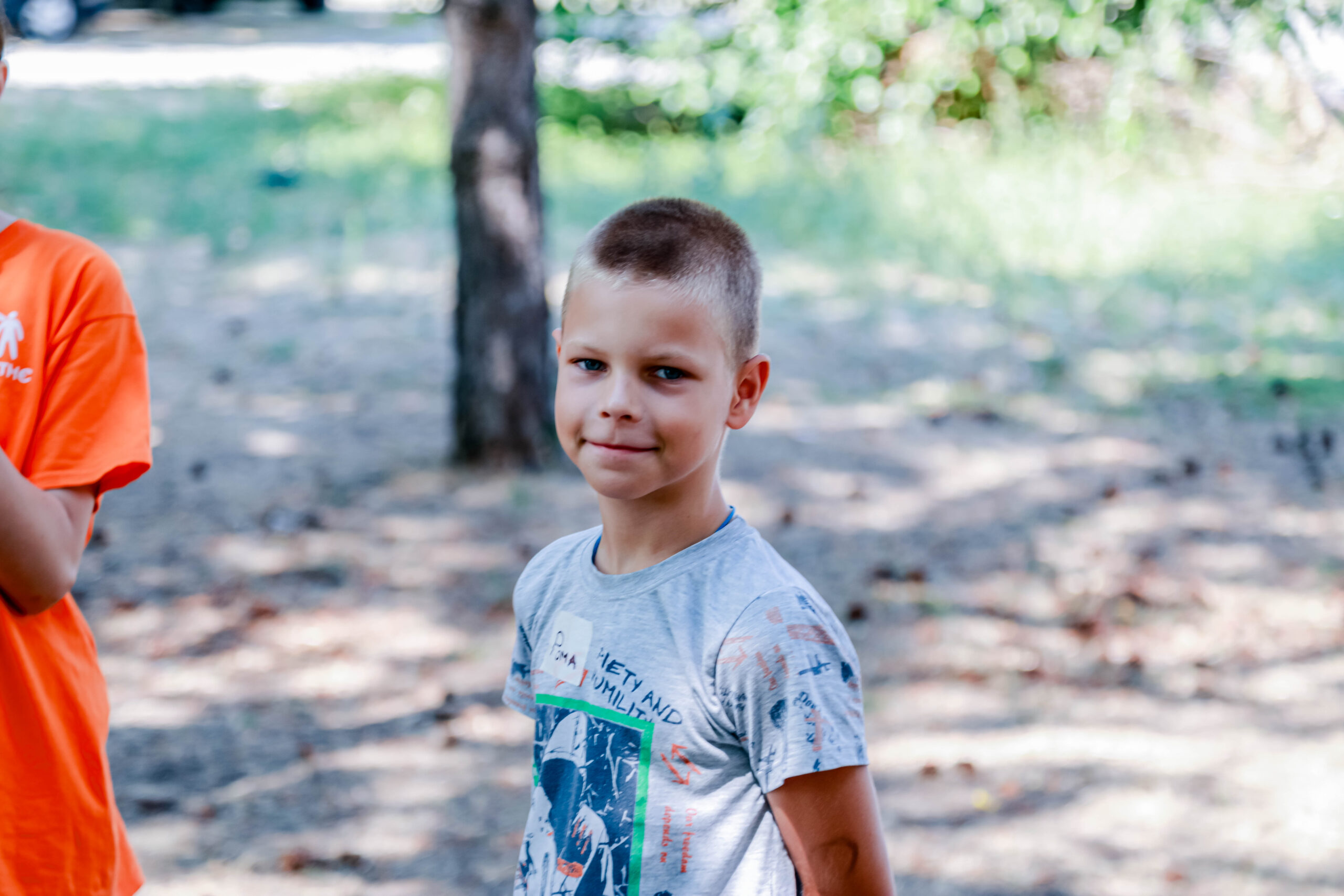 Boy smiling outside at summer bible camp