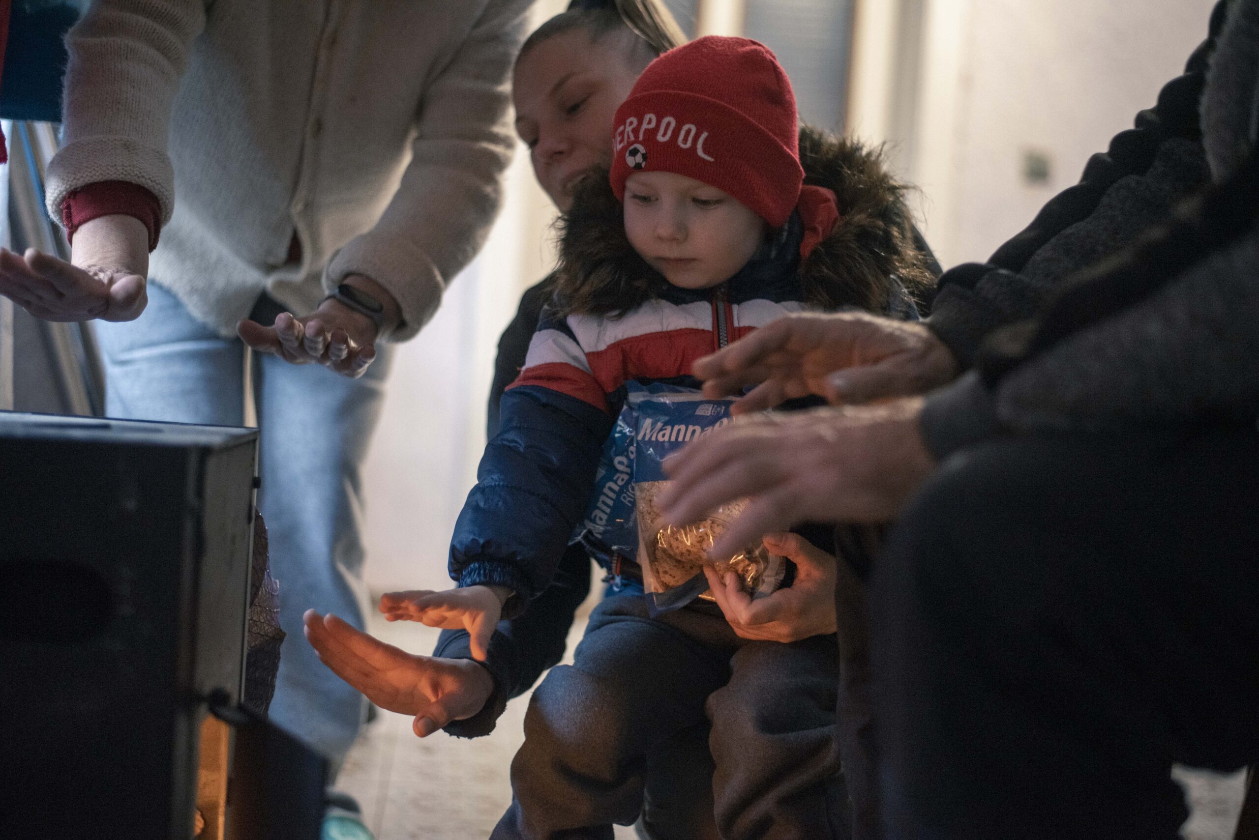child and mother warming up near wood buring stove