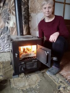 lady next to a wood burining stove