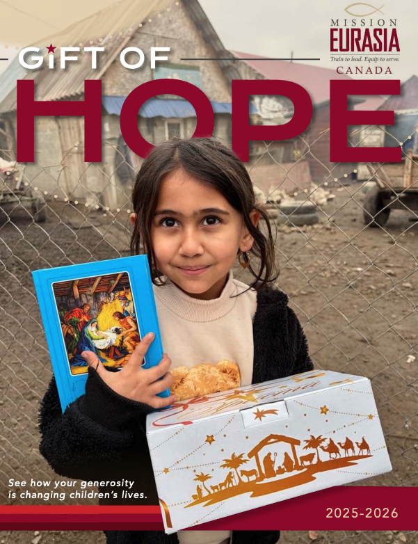 Mission Eurasia report cover with little girl holding bible and gift of hope box