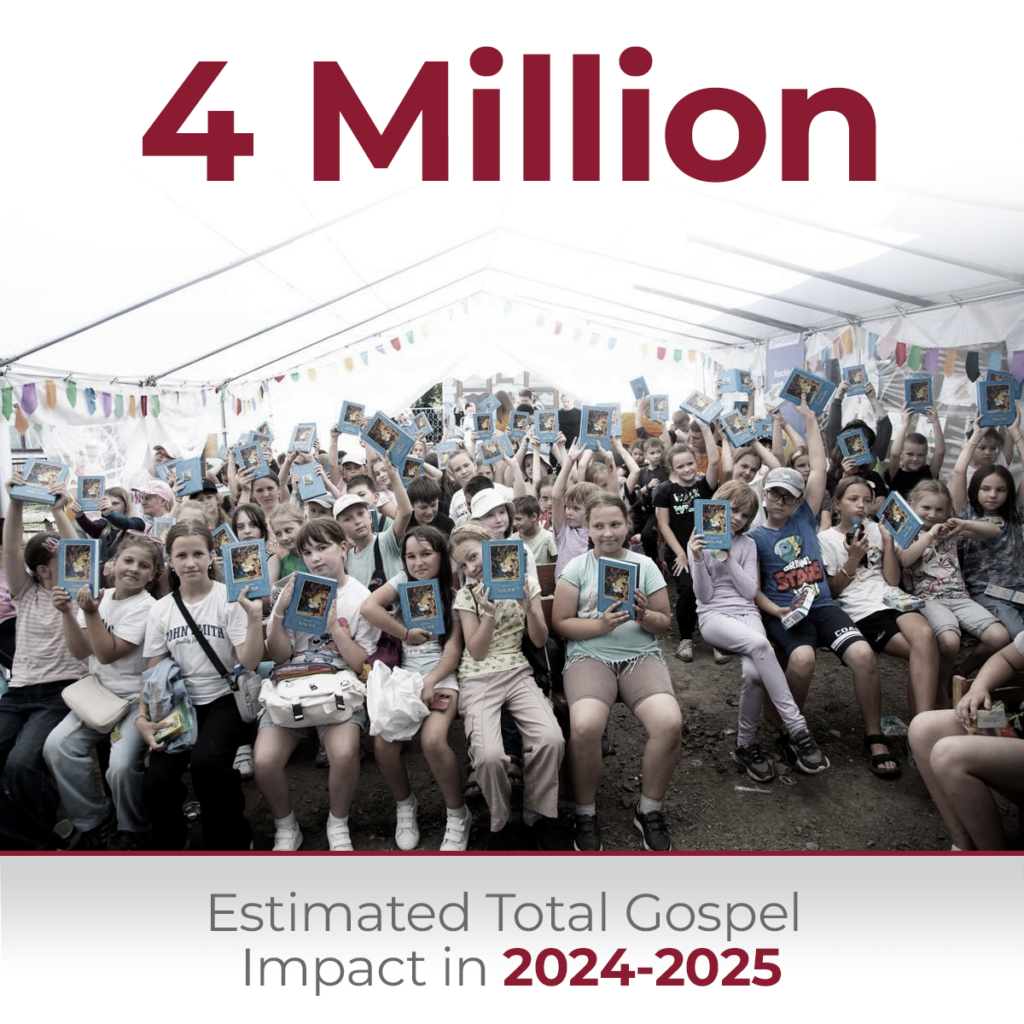 A large group of smiling children gathered outdoors under a white tent canopy, joyfully holding up identical blue children's storybooks, with text overlay reading 4 Million Estimated Total Gospel Impact in 2024-2025.