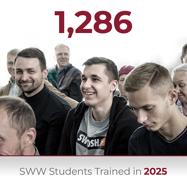 A large group of smiling youth and adults sitting together in an auditorium or classroom during a training session, with text overlay reading 1,286 SWW Students Trained in 2025.