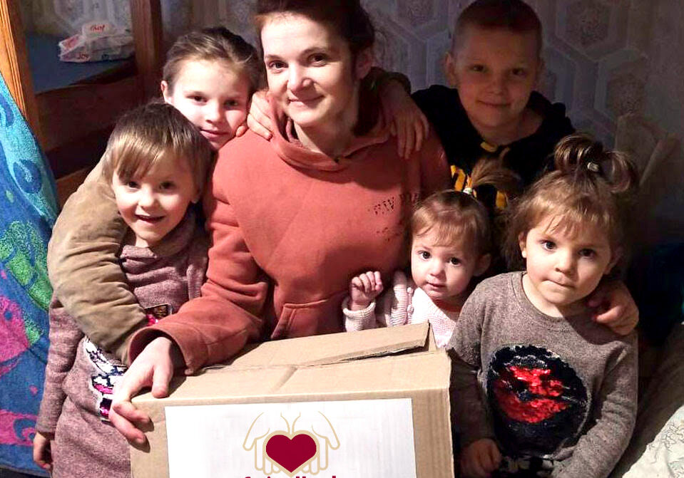 give to where needed most young mother with her young children with caring hands gift
