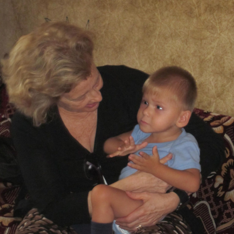 Anita Deyneka holding an orphaned boy